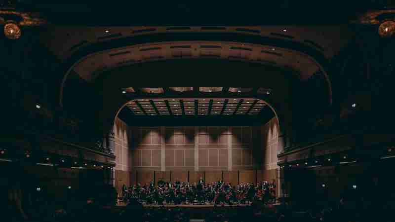 Orchestra performing a symphony in a grand theater, showcasing exquisite classical music., tags: bambergs musikalische identität - pexel